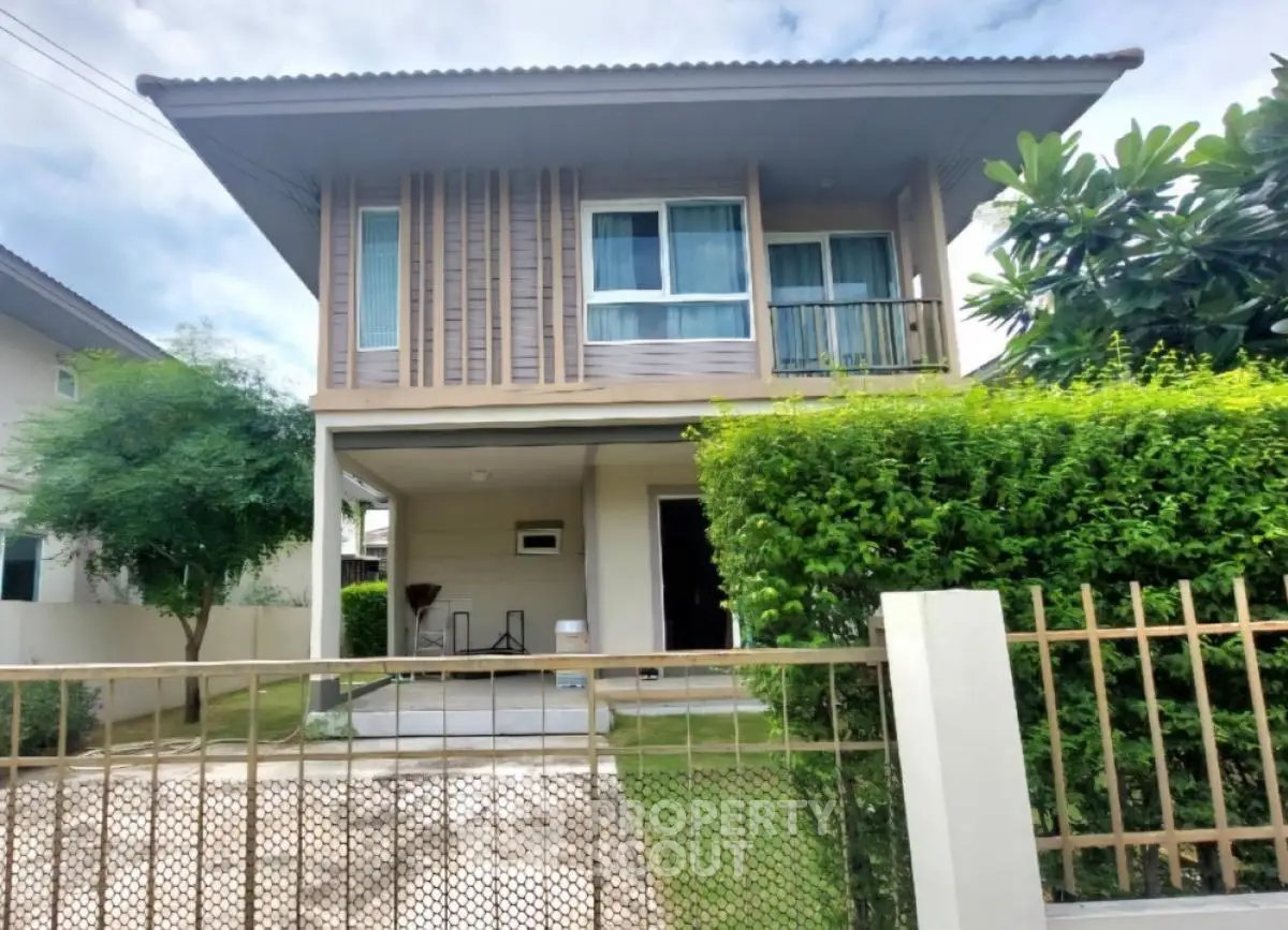Modern two-story house with lush greenery and spacious front yard