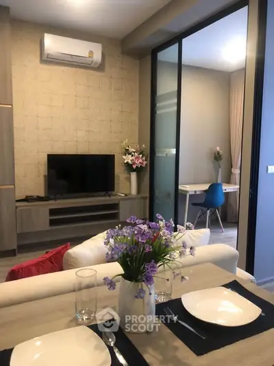 Modern living room with stylish decor and open layout, featuring a cozy dining area and elegant furnishings.