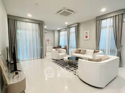 Spacious modern living room with elegant white sofas and large windows