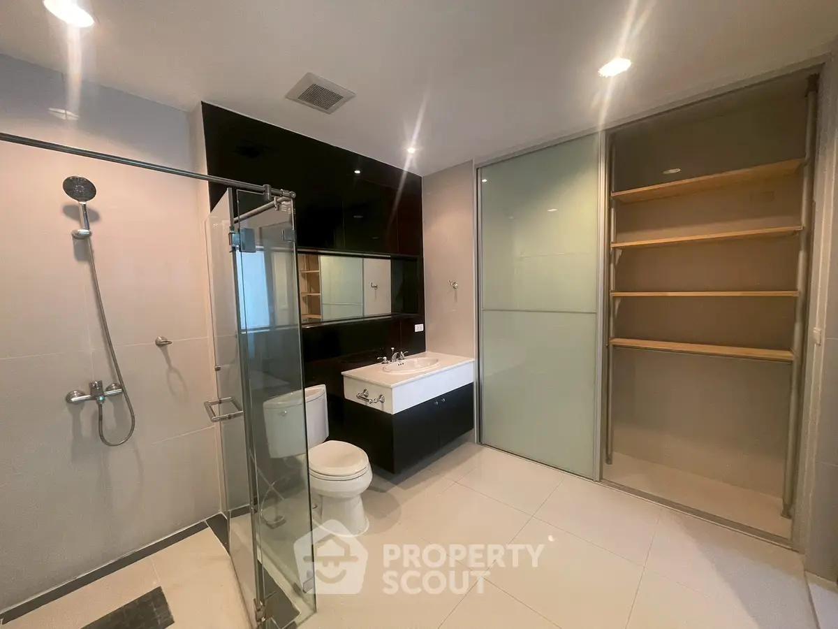 Spacious modern bathroom with glass shower and sleek fixtures