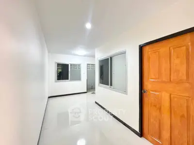Spacious hallway with modern design and wooden door