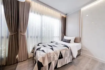 Modern bedroom with stylish decor and large windows for natural light