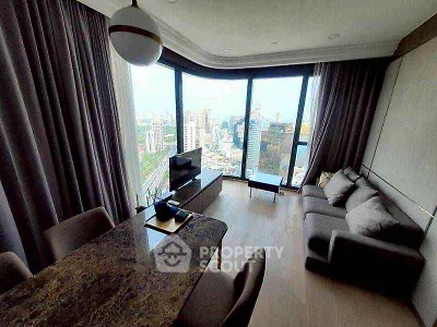 Modern living room with panoramic city view and elegant furnishings.