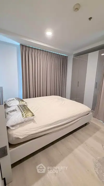 Modern bedroom with sleek design, featuring a comfortable bed and stylish wardrobe, perfect for urban living.