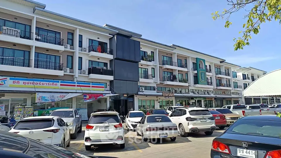 Modern commercial building with parking lot and retail shops