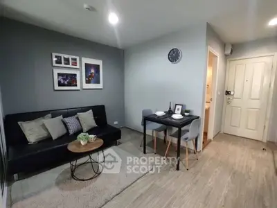 Modern living room with stylish decor and dining area in a cozy apartment.