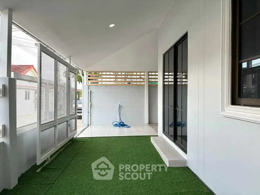 Modern home exterior with artificial grass and sleek design