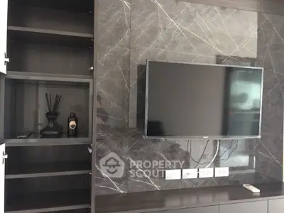 Modern living room with sleek TV setup and elegant shelving unit.
