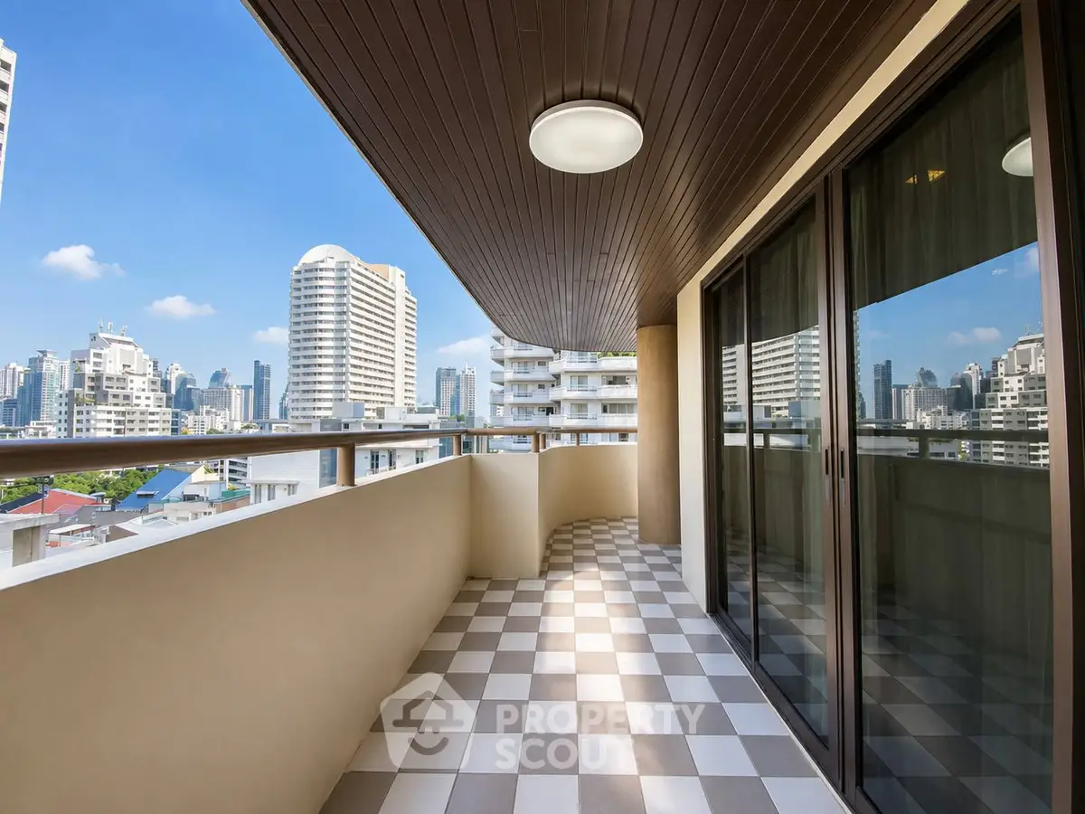 Spacious balcony with city skyline view, perfect for relaxation and entertainment.