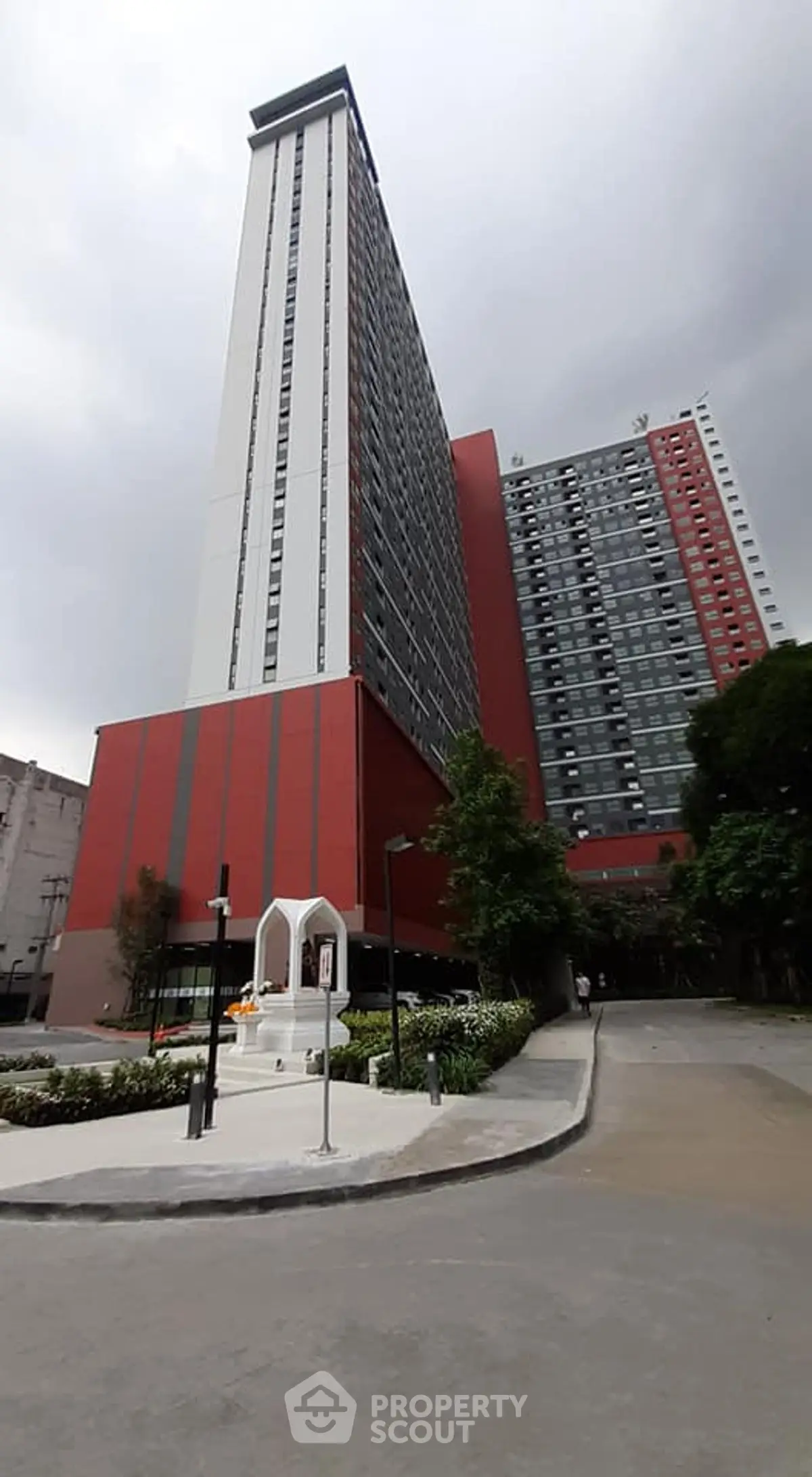 Modern high-rise building with sleek architecture and landscaped surroundings