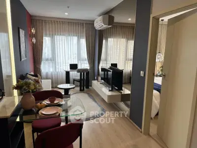 Modern living room with stylish decor and open layout, featuring a cozy dining area and large windows.