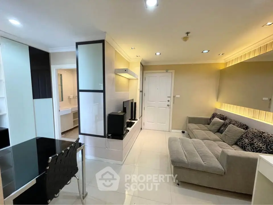 Modern living room with sleek furniture and ambient lighting in a stylish apartment.