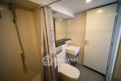 Modern bathroom with sleek fixtures and a spacious shower area.