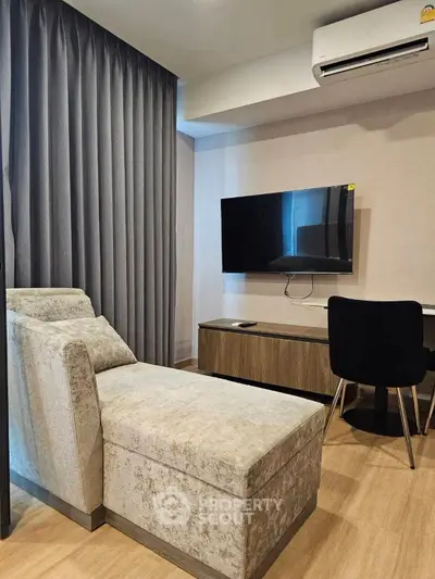 Modern living room with sleek furniture and wall-mounted TV