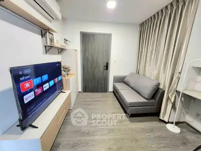Modern living room with sleek design, featuring a cozy sofa, wall-mounted TV, and stylish decor.