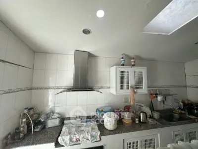 Spacious kitchen with modern hood and ample countertop space