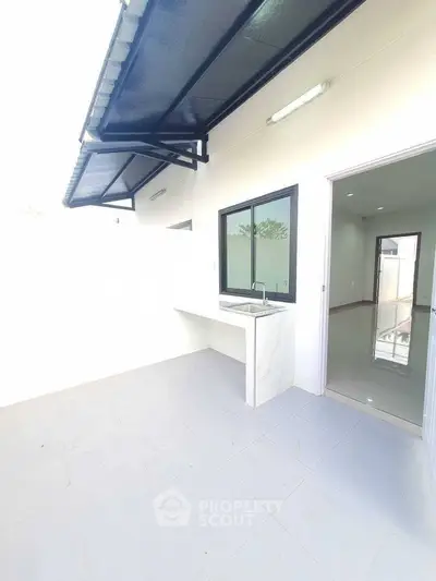 Modern outdoor kitchen with sleek design and ample natural light