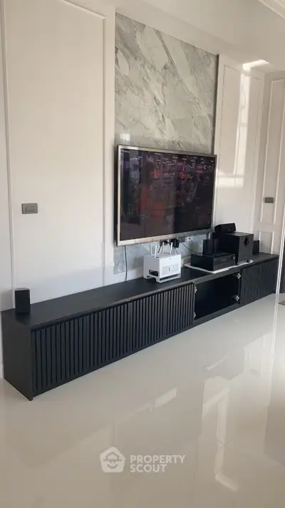 Modern living room with sleek TV unit and marble accent wall