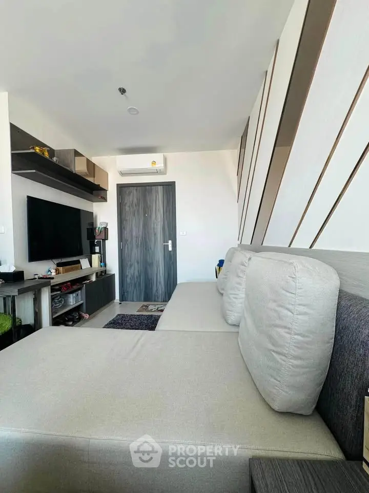 Modern living room with sleek design and comfortable seating in a stylish apartment.