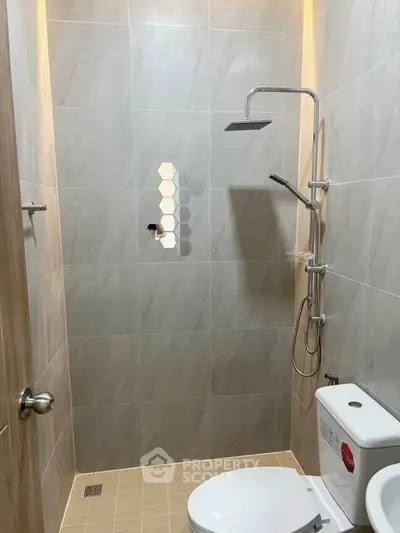 Modern bathroom with sleek shower and toilet in minimalist design