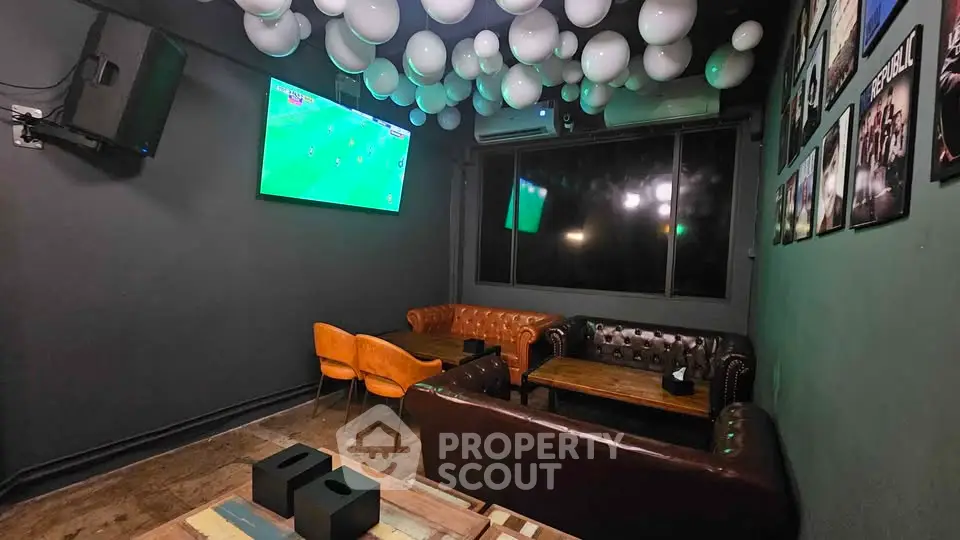 Stylish lounge with leather sofas and wall-mounted TV, perfect for entertainment.