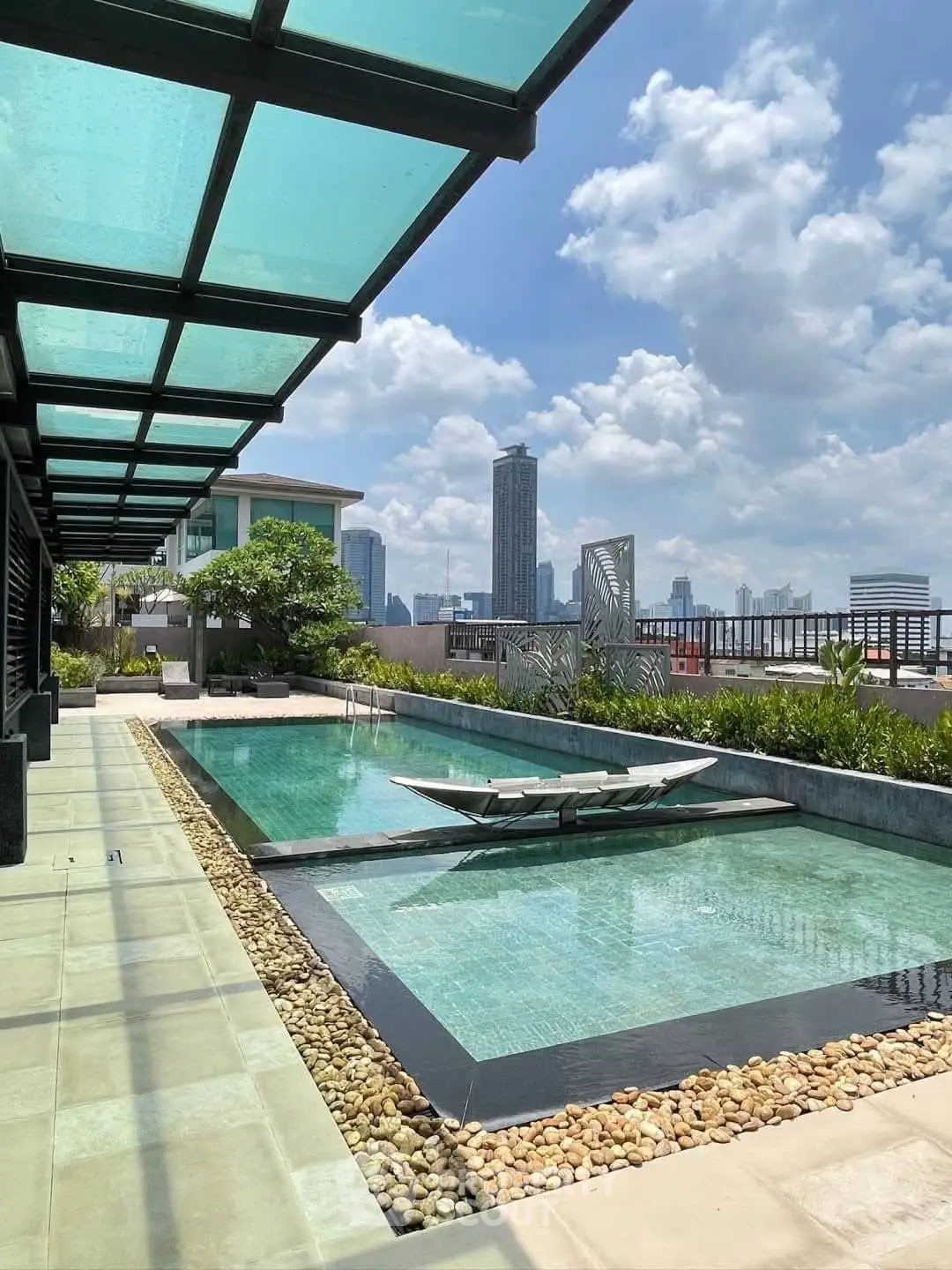 Luxurious rooftop pool with stunning city skyline views and modern design.