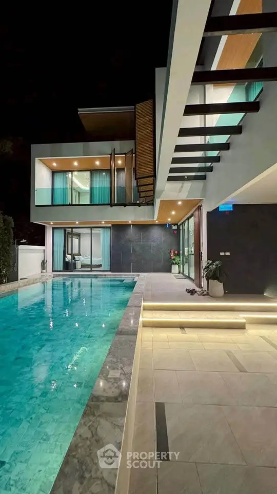 Luxurious modern villa with stunning pool and elegant architecture at night