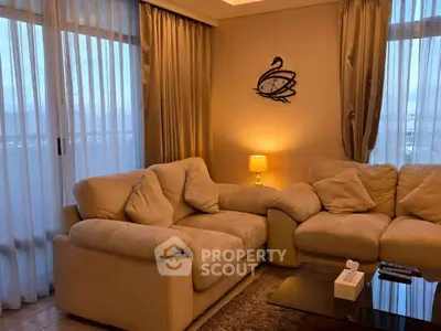 Cozy living room with plush sofas and ambient lighting in a modern apartment.