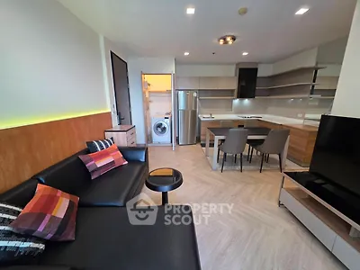 Modern open-layout living room with sleek kitchen and stylish furniture
