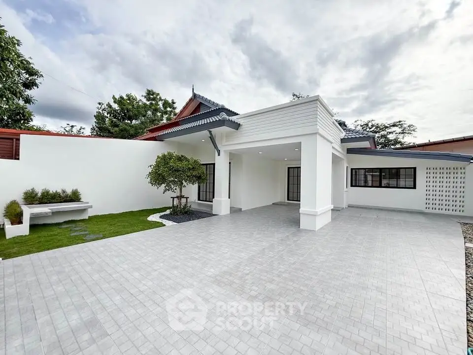 Spacious modern home exterior with large driveway and lush greenery, perfect for family living.