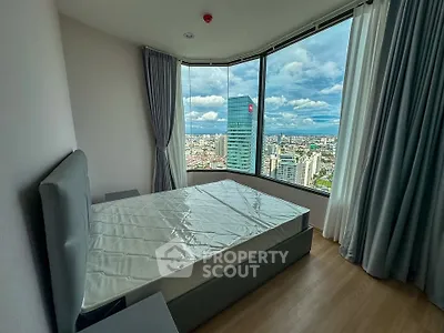 Stunning bedroom with panoramic city view from high-rise apartment