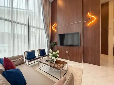 Luxurious living room with high ceilings, modern decor, and large windows for natural light.