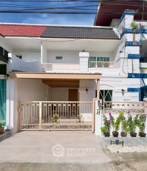 Charming two-story house with gated entrance and balcony, ideal for family living.