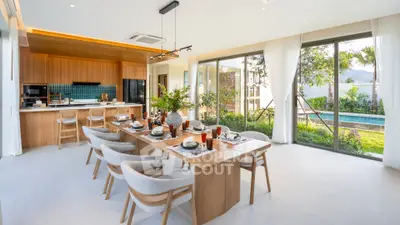 Luxurious open-plan dining area with pool view, modern kitchen, and elegant decor.
