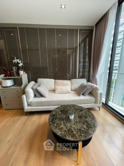 Modern living room with elegant marble coffee table and plush sofa near large window.