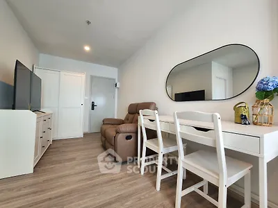 Modern living room with stylish furniture and elegant decor, featuring a cozy seating area and sleek wooden flooring.