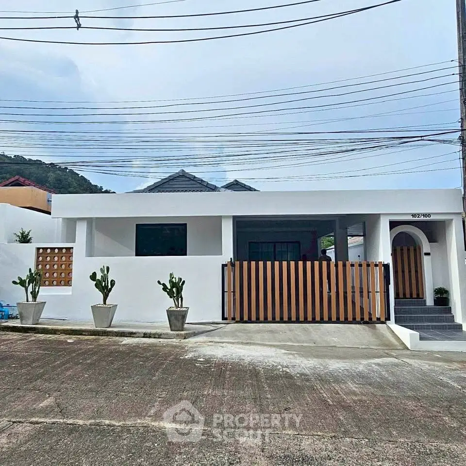Charming modern house with sleek design and gated entrance in a serene neighborhood.
