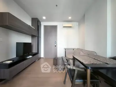 Modern living room with sleek furniture and wall-mounted TV in a stylish apartment.