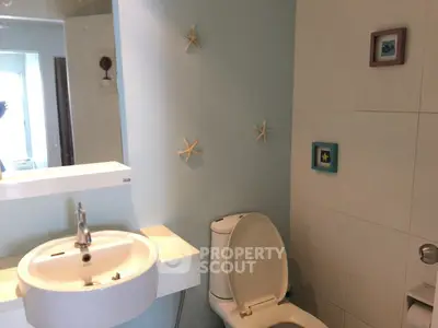 Charming bathroom with modern fixtures and coastal decor accents.