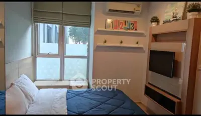 Cozy bedroom with modern decor and large window for natural light