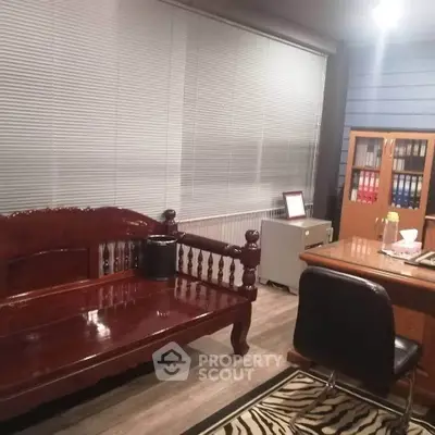 Cozy home office with wooden furniture and zebra print rug, perfect for productivity.