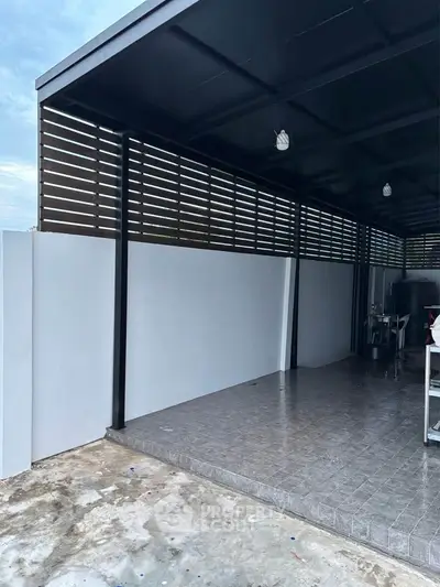 Modern covered outdoor space with tiled flooring and sleek design, perfect for versatile use.