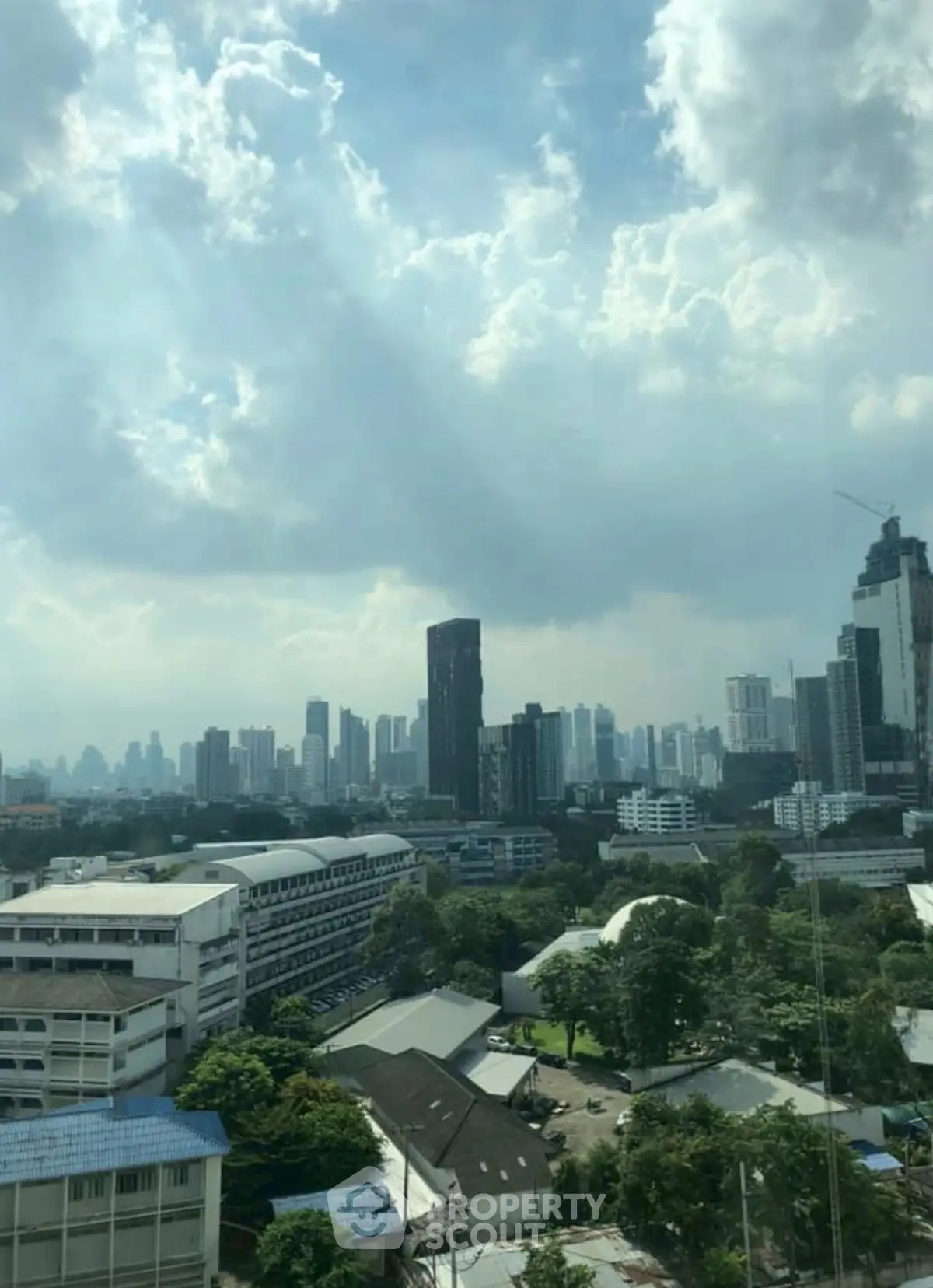 Stunning cityscape view with modern skyscrapers and lush greenery, perfect for urban living enthusiasts.