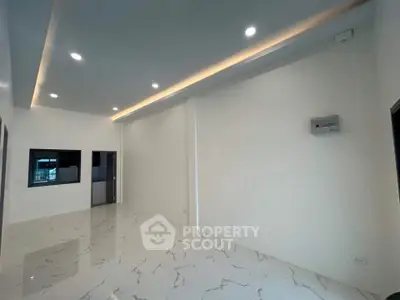 Spacious modern interior with marble flooring and recessed lighting, ideal for customization.