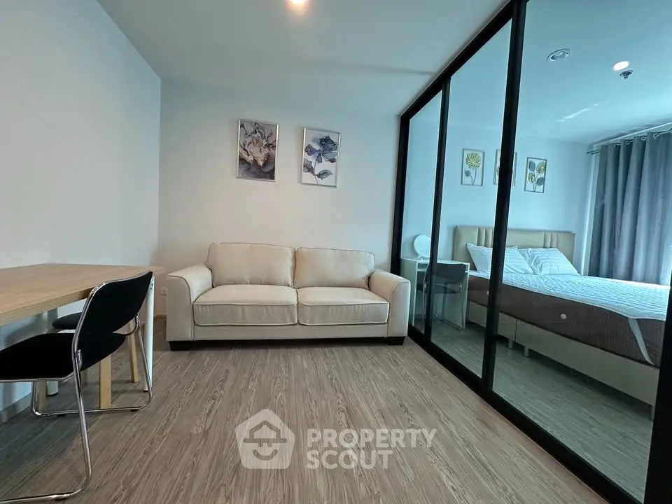 Modern living room with glass partition and cozy bedroom view