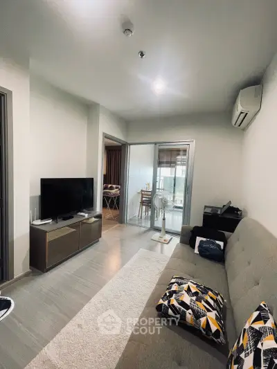 Modern living room with stylish decor and open layout, featuring a cozy sofa and sleek TV unit.