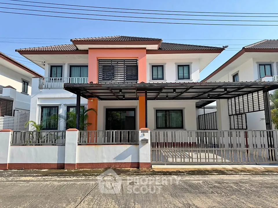 Modern two-story house with a spacious carport and stylish facade in a suburban neighborhood.
