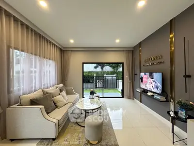 Elegant living room with modern decor and large windows in a luxury home.