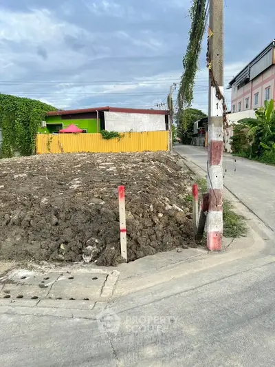 Vacant land plot in urban area with potential for development, surrounded by residential buildings.