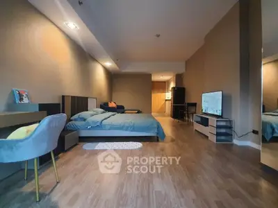 Spacious modern bedroom with stylish decor and wooden flooring